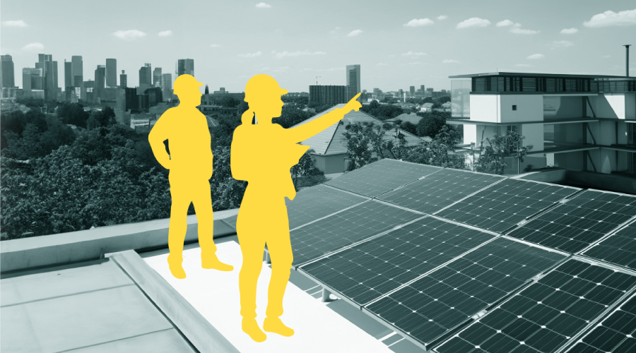 Two engineer silhouettes on a city building rooftop with photovoltaic panels. 