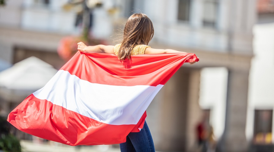Young girl with Austrian flag on back