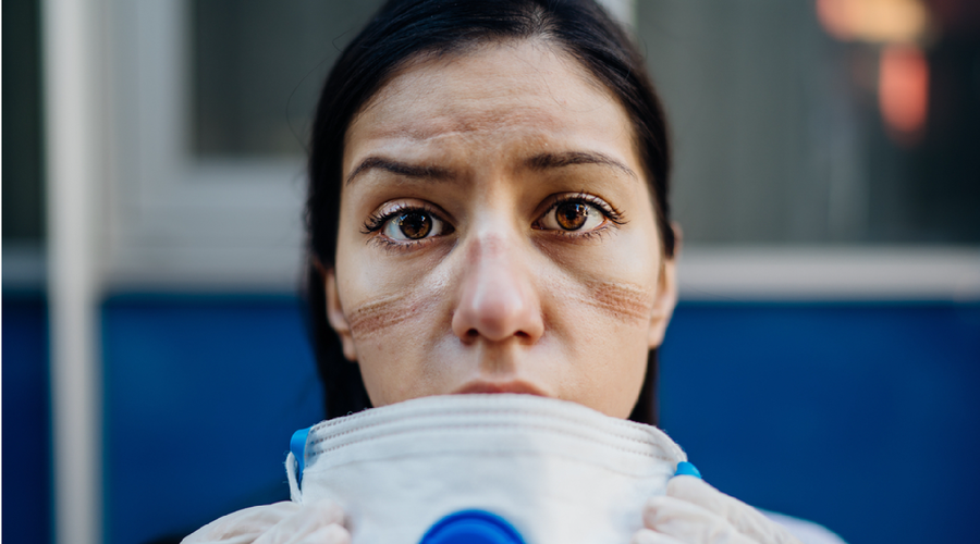Female medical worker taking off a face mask