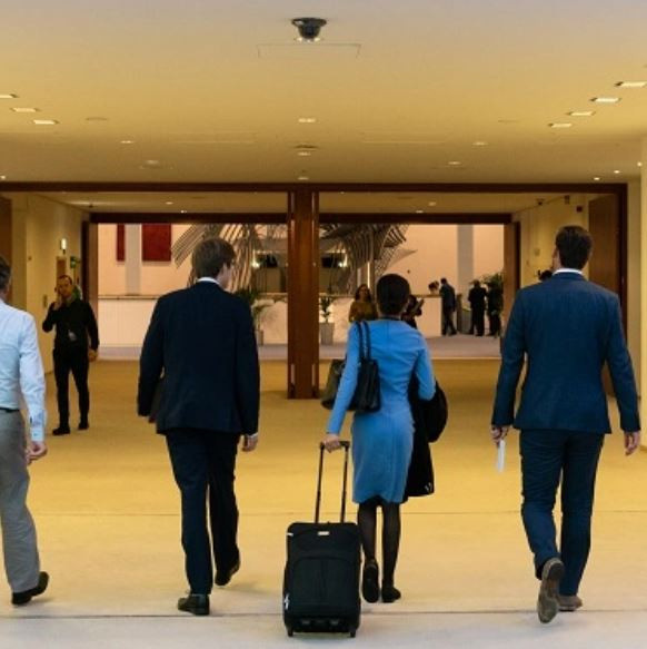 Men and women walking into an administrative building