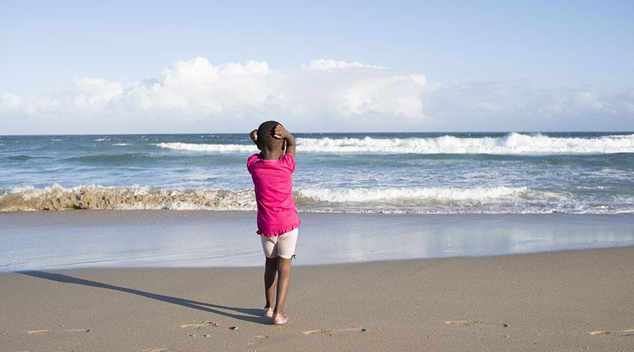 Young girl gazes out to the sea