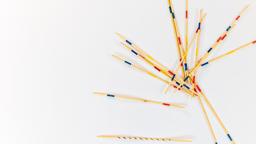 Mikado sticks scattered on white background