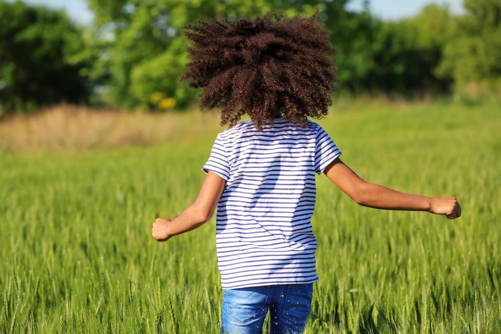 Little girl in green field 