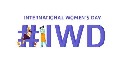 'International Women's Day' and '#IWD' written on large block letters with drawn female characters sitting and looking optimistic on the hashtag